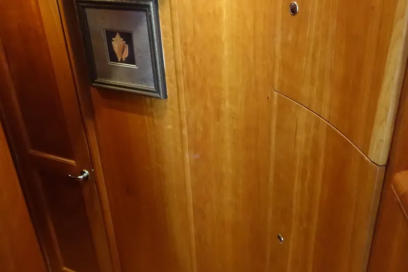 Slide: The Image of Interior of 2001 Silverton 410 Sport Bridge with wooden paneling and framed artwork. - 17