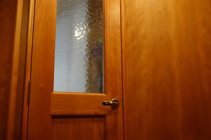 Slide: The Image of Wooden door with frosted glass panel on a 2001 Silverton 410 Sport Bridge. - 19