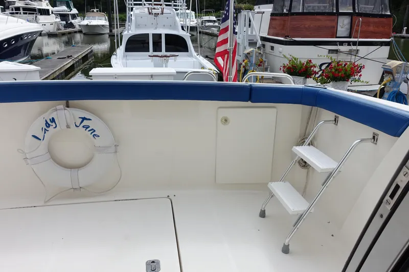 Slide: The Image of 2001 Silverton 410 Sport Bridge yacht deck with life preserver and ladder. - 2