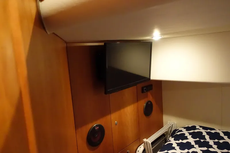 Slide: The Image of Interior of 2001 Silverton 410 Sport Bridge with TV and speaker setup. - 20