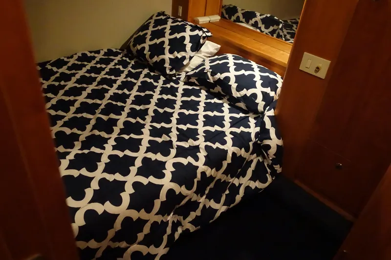 Slide: The Image of Cozy bedroom in 2001 Silverton 410 Sport Bridge with patterned bedding. - 21