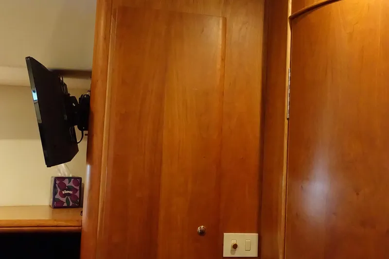 Slide: The Image of Interior of 2001 Silverton 410 Sport Bridge with mounted TV and wooden paneling. - 25