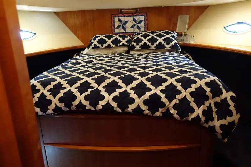 Slide: The Image of Cozy bedroom in 2001 Silverton 410 Sport Bridge yacht with patterned bedding. - 27