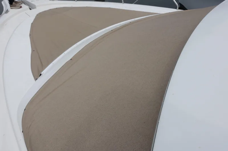 Slide: The Image of 2001 Silverton 410 Sport Bridge with beige canvas covers on deck. - 3