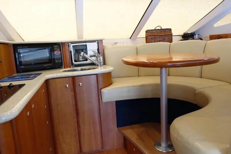 Slide: The Image of 2001 Silverton 410 Sport Bridge interior with kitchenette and curved seating area. - 34