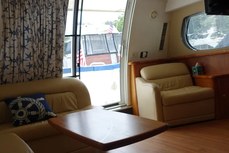 Slide: The Image of Interior of 2001 Silverton 410 Sport Bridge with cozy seating and nautical decor. - 39