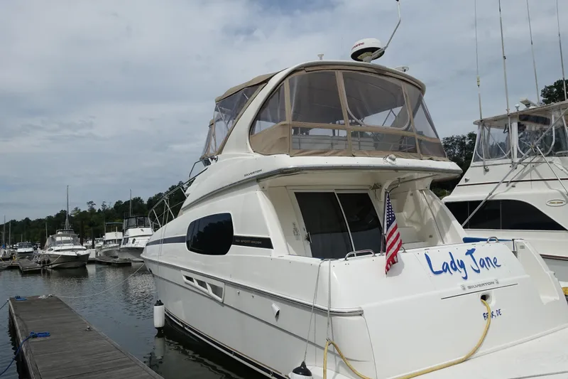 Slide: The Image of 2001 Silverton 410 Sport Bridge yacht docked at marina, named "Lady Jane." - 41