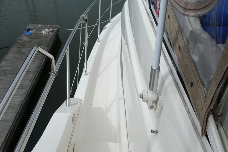 Slide: The Image of 2001 Silverton 410 Sport Bridge yacht deck with railing, docked at marina. - 6