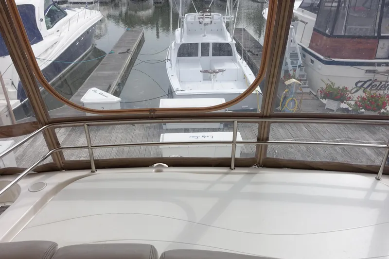 Slide: The Image of 2001 Silverton 410 Sport Bridge yacht docked at marina, view from interior. - 8