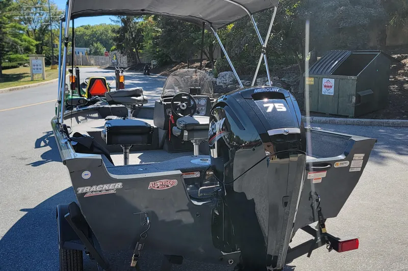 Slide: The Image of 2022 Tracker Pro Guide V-16 SC boat with Mercury 75 engine on a sunny day. - 2
