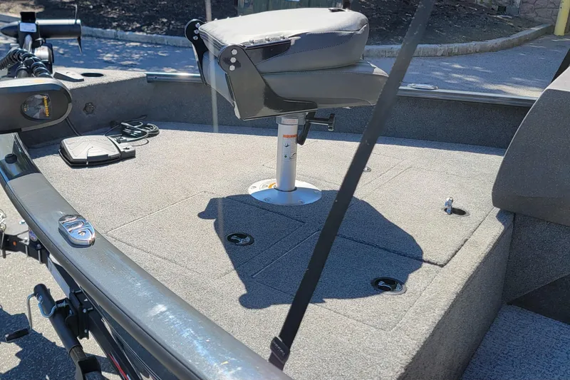 Slide: The Image of 2022 Tracker Pro Guide V-16 SC boat interior with swivel seat and fishing equipment. - 5