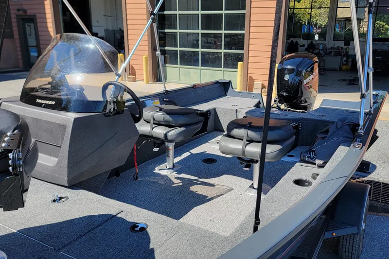 Slide: The Image of 2022 Tracker Pro Guide V-16 SC boat interior with seating and controls. - 6