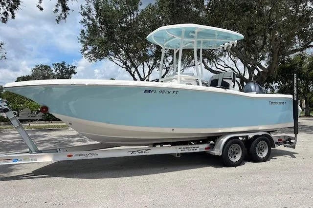 The Image of 2023 Tidewater 220 CC Adventure boat on trailer, light blue hull, sunny day. - 0