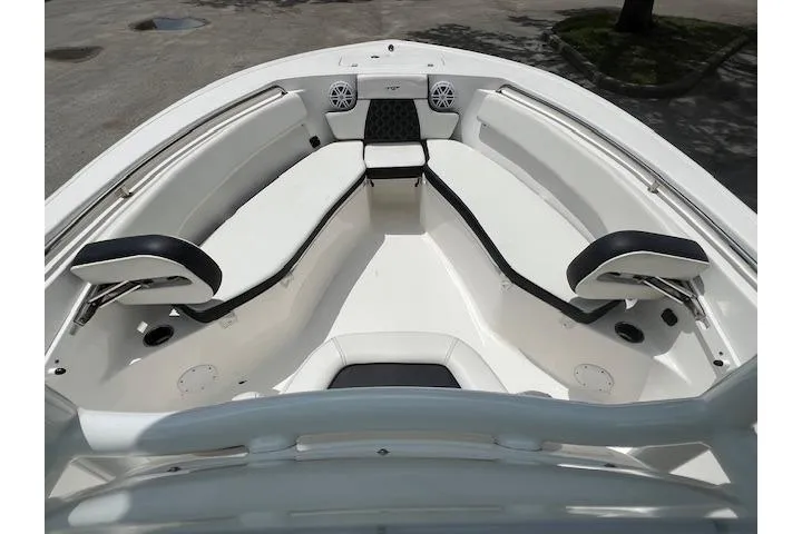 Slide: The Image of 2023 Tidewater 220 CC Adventure boat interior with cushioned seating and speakers. - 10