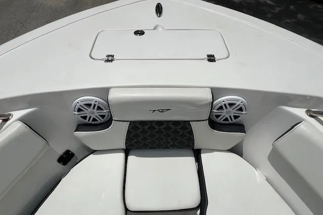 Slide: The Image of 2023 Tidewater 220 CC Adventure boat interior with cushioned seating and speakers. - 11