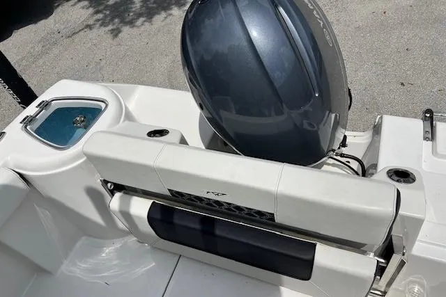 Slide: The Image of 2023 Tidewater 220 CC Adventure boat with outboard motor and seating area. - 2