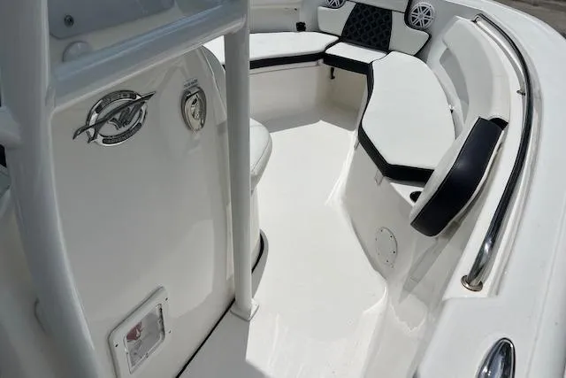 Slide: The Image of 2023 Tidewater 220 CC Adventure boat interior with cushioned seating and sleek design. - 6