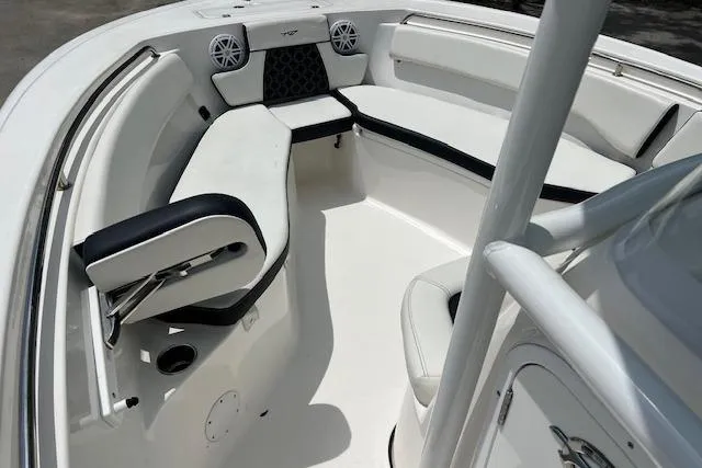 Slide: The Image of 2023 Tidewater 220 CC Adventure boat interior with cushioned seating and speakers. - 8