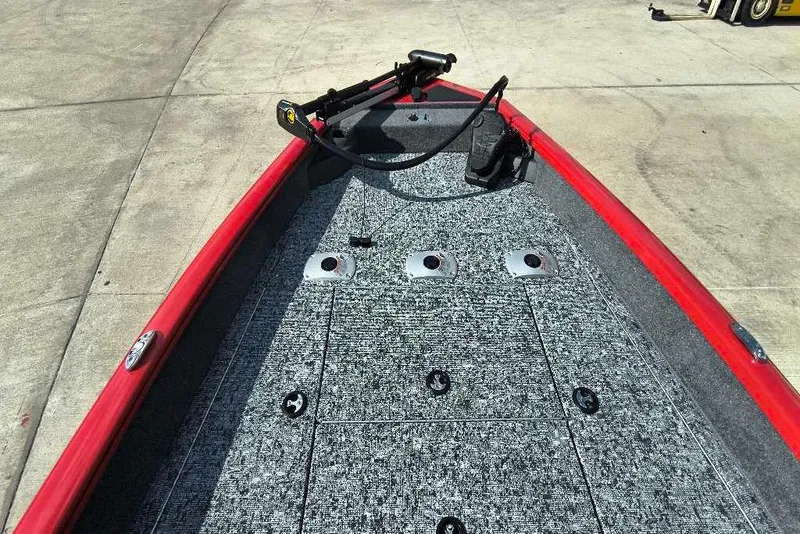 Slide: The Image of 2026 Tracker Pro Team 175 Crappie Edition boat deck with red trim and fishing rod holders. - 5