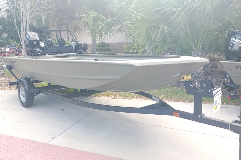 The Image of 2026 Tracker Grizzly 1754 Utility boat on trailer, parked outdoors. - 0