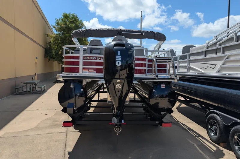Slide: The Image of 2025 Ranger Reata 220FC pontoon boat with 150 horsepower engine, parked outdoors. - 8