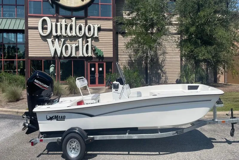The Image of 2026 Mako Pro Skiff 17 CC boat on trailer outside Outdoor World store. - 0