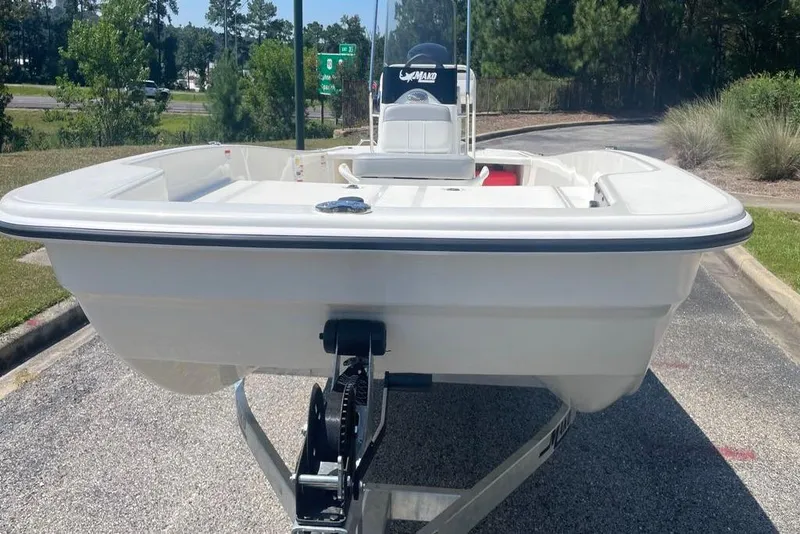 Slide: The Image of 2026 Mako Pro Skiff 17 CC boat on trailer, parked outdoors. - 2