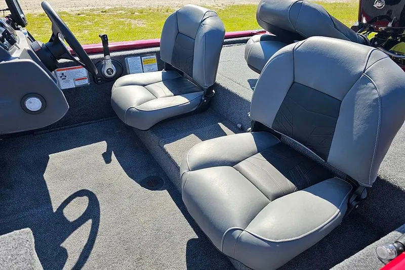 Slide: The Image of 2026 Tracker Pro 170 boat interior with gray seating and steering console. - 10