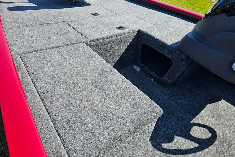 Slide: The Image of 2026 Tracker Pro 170 boat interior with gray carpet and red trim. - 12