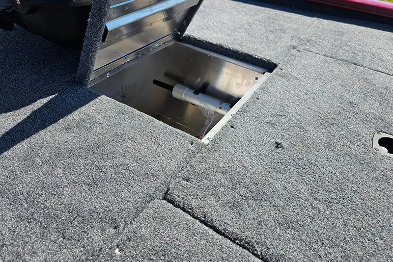 Slide: The Image of Carpeted deck of 2026 Tracker Pro 170 boat with open storage compartment. - 13