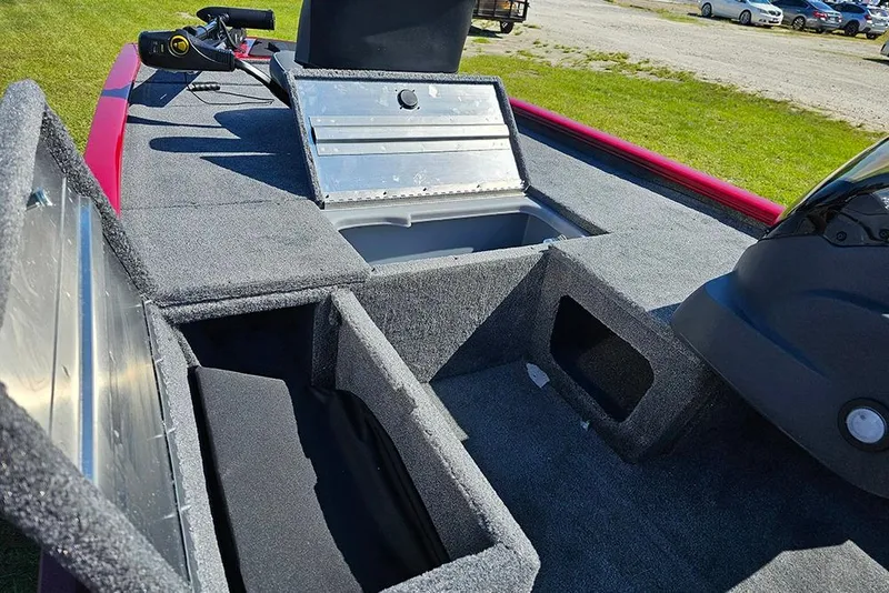 Slide: The Image of 2026 Tracker Pro 170 boat interior with open storage compartments and carpeted flooring. - 14