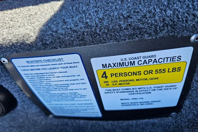 Slide: The Image of 2026 Tracker Pro 170 boat capacity label, showing maximum 4 persons or 555 lbs. - 16