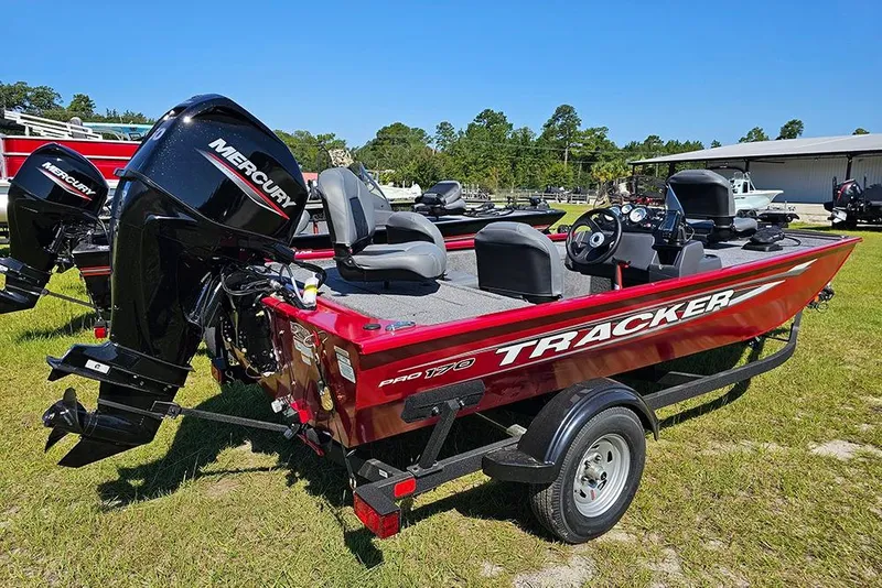 Slide: The Image of 2026 Tracker Pro 170 boat with Mercury engine on grassy area. - 3