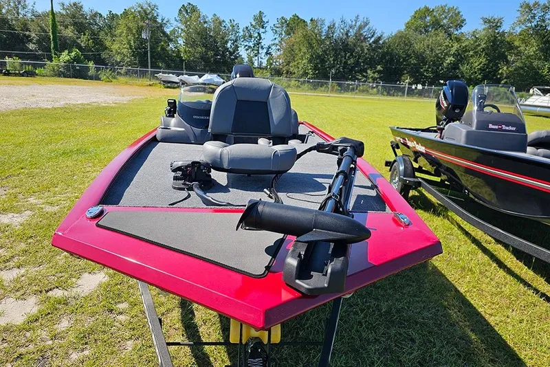 Slide: The Image of 2026 Tracker Pro 170 boat with red deck, parked on grass. - 4