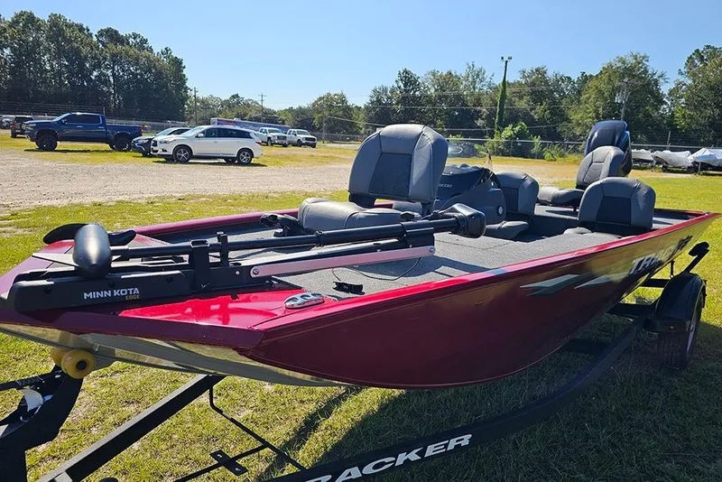 Slide: The Image of 2026 Tracker Pro 170 boat with Minn Kota motor, parked on grass. - 5