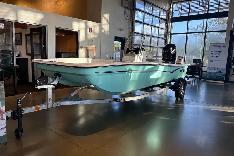 The Image of 2026 Mako Pro Skiff 17 CC boat displayed indoors on a trailer. - 0