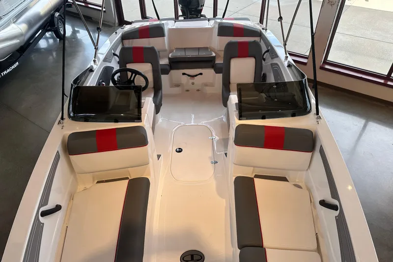 Slide: The Image of 2026 Tahoe T21 boat interior with red and gray seating, steering wheel, and spacious layout. - 104