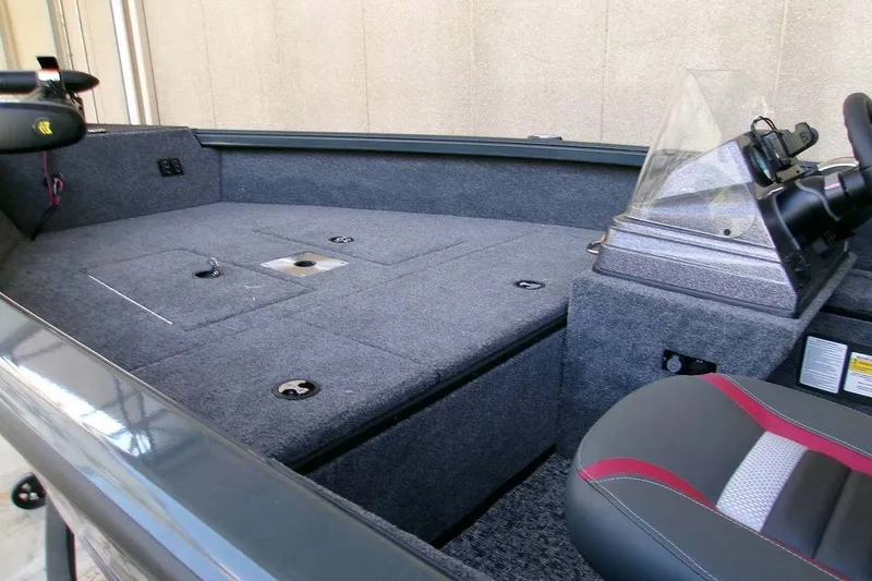 Slide: The Image of 2025 Ranger VS1665SC boat interior with gray carpet and modern seating. - 7
