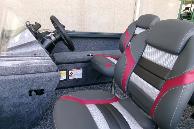 Slide: The Image of 2025 Ranger VS1665SC boat interior with stylish seats and steering wheel. - 8