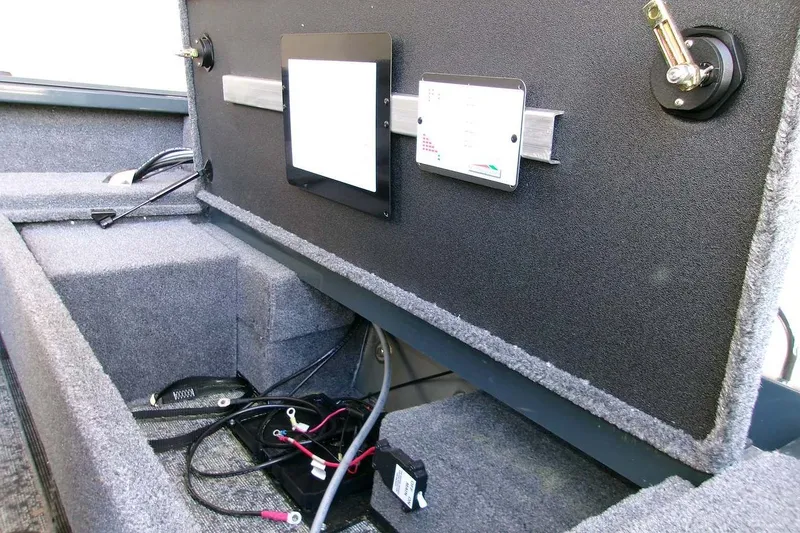 Slide: The Image of Interior of 2025 Ranger VS1665SC boat showing storage compartment and wiring setup. - 9