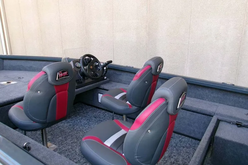 Slide: The Image of 2025 Ranger VS1665SC boat interior with gray and red seating, steering console, and carpeted flooring. - 6