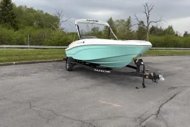 Slide: The Image of 2026 Tahoe T16 boat on trailer, parked in outdoor setting with greenery. - 1