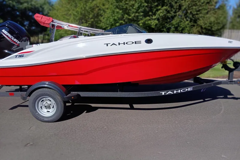 The Image of 2026 Tahoe T16 boat with red and white design on a trailer. - 0