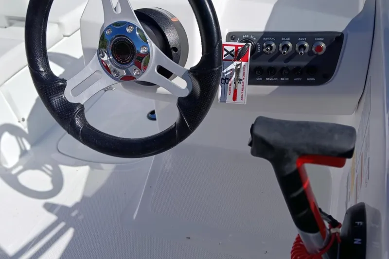 Slide: The Image of Steering wheel and control panel of 2026 Tahoe T16 boat cockpit. - 2