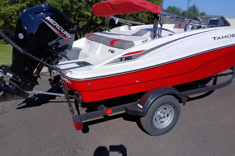 Slide: The Image of 2026 Tahoe T16 boat with Mercury engine on a trailer, red and white design. - 4
