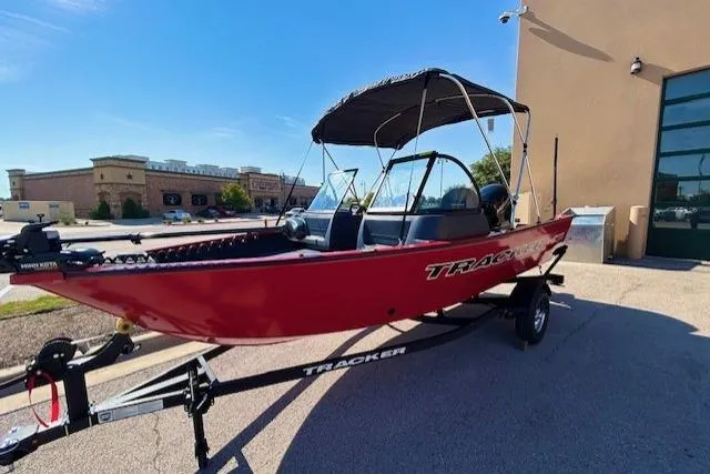 Slide: The Image of 2026 Tracker Pro Guide V-16 WT boat, red, on trailer, parked outdoors. - 3