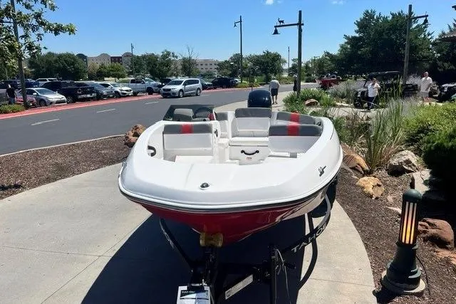 Slide: The Image of 2026 Tahoe T16 boat on trailer in parking lot, sunny day, trees in background. - 63