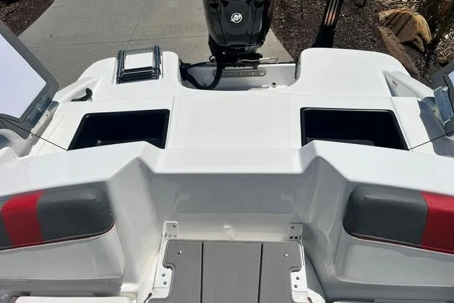Slide: The Image of 2026 Tahoe T16 boat stern with storage compartments and motor, docked on a sunny day. - 66