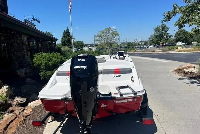 Slide: The Image of 2026 Tahoe T16 boat with 75 HP engine, parked outdoors on a sunny day. - 61