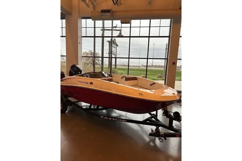 Slide: The Image of 2026 Tahoe T16 boat displayed indoors with large windows in the background. - 60